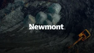 Aerial view of an open pit gold mine with a haul truck, with Newmont logo overlaid