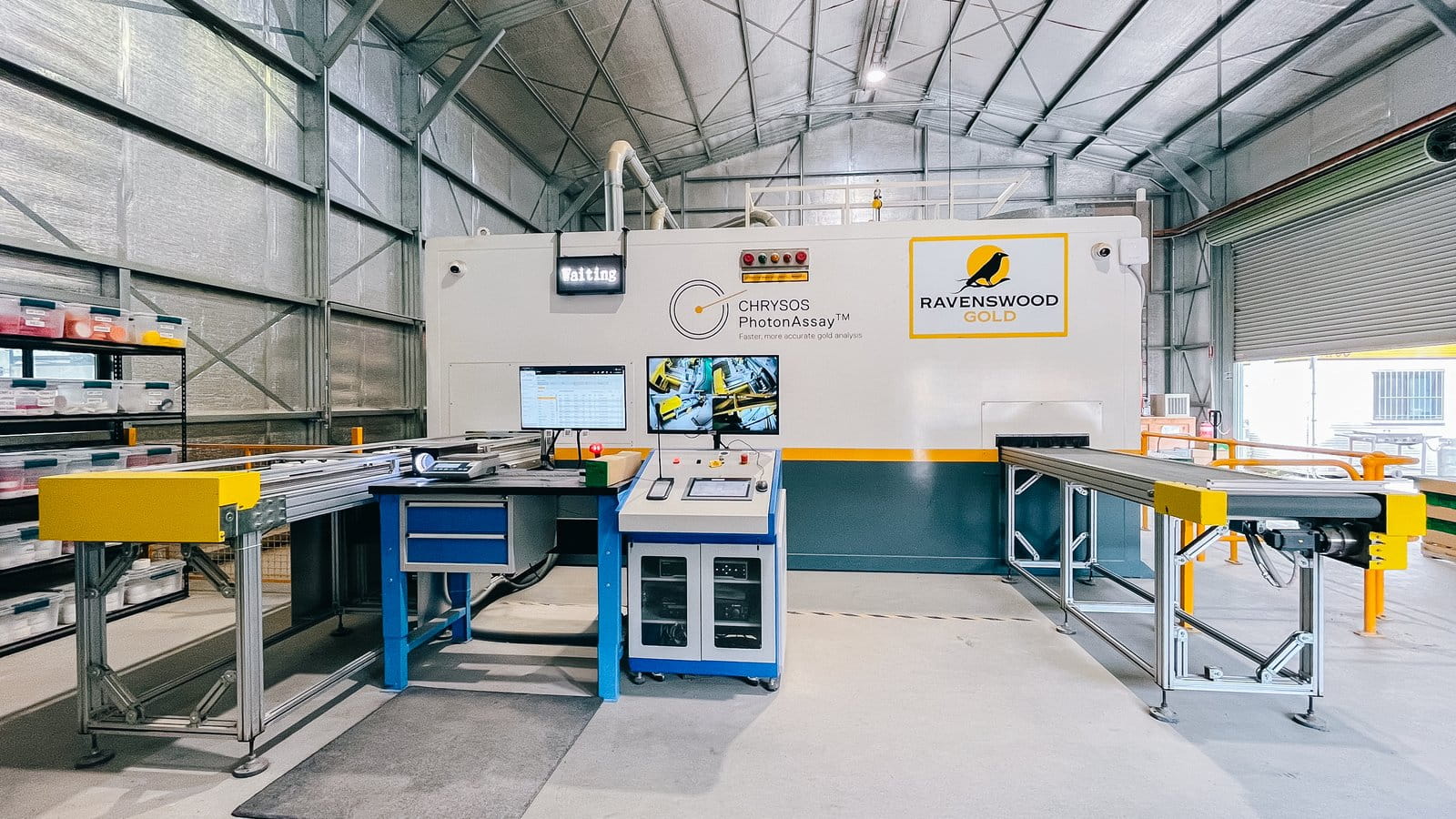Chrysos PhotonAssay™ unit installed at Ravenswood Gold Mine, Queensland, showing the full system with conveyor, operator workstation, and Ravenswood Gold branding