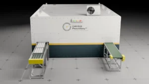 3D render of a PhotonAssay™ 1408X unit showing the full system including conveyor, irradiation cabinet, and sample entry point