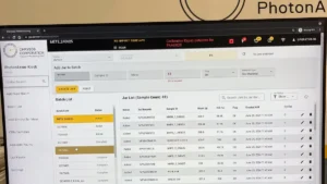PhotonAssay™ OperatorUI displayed on a monitor, showing a sample batch list and jar data dashboard