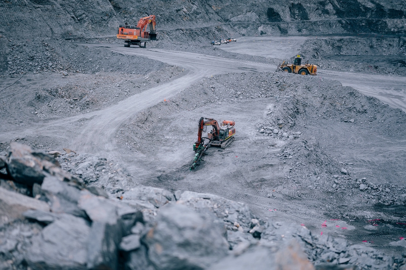 Aerial view of excavators and loader operating in the open pit at Macraes Gold Mine, South Island, New Zealand