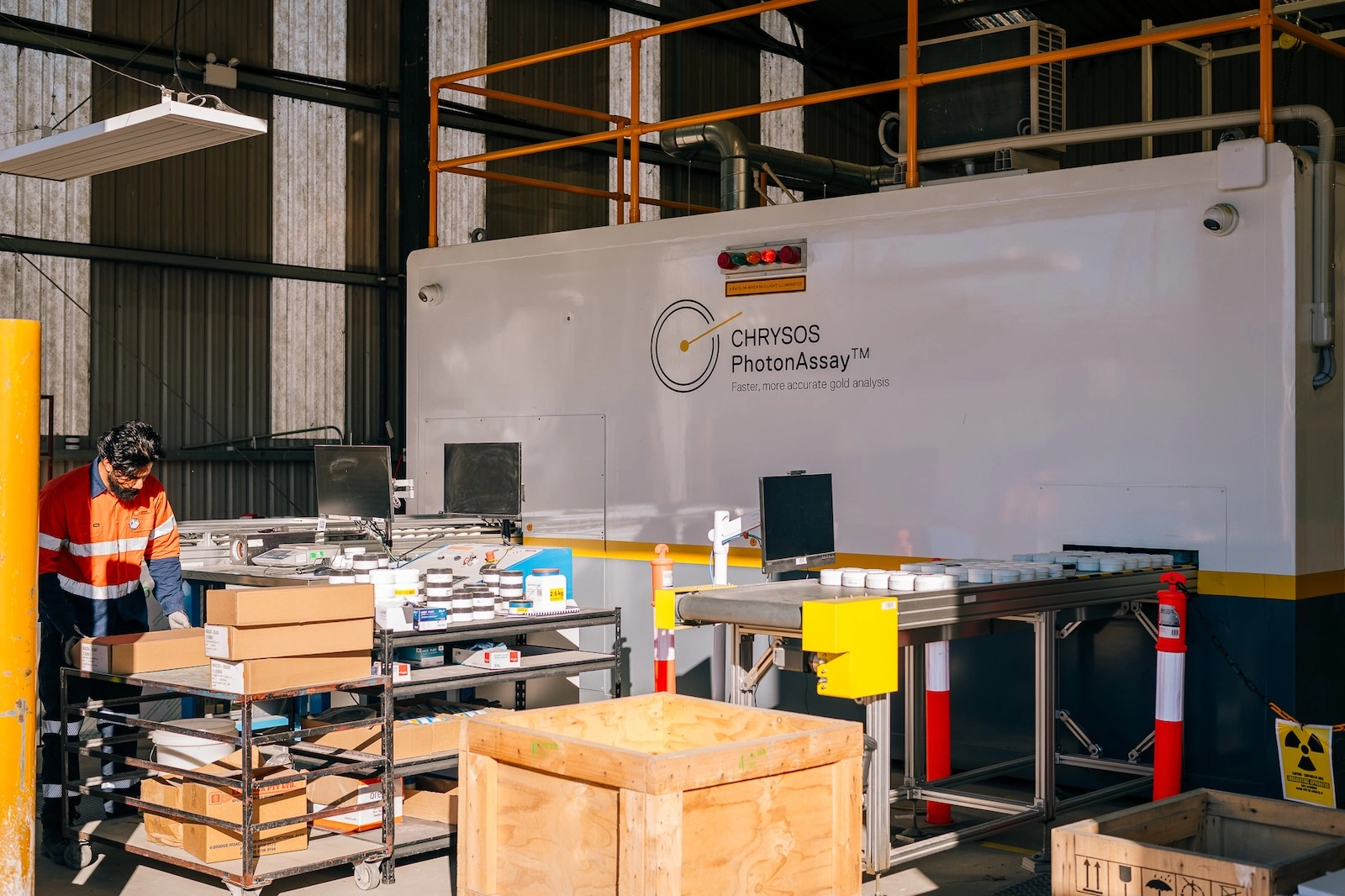 Chrysos PhotonAssay™ unit at Macraes Gold Mine with technician loading sample jars for analysis