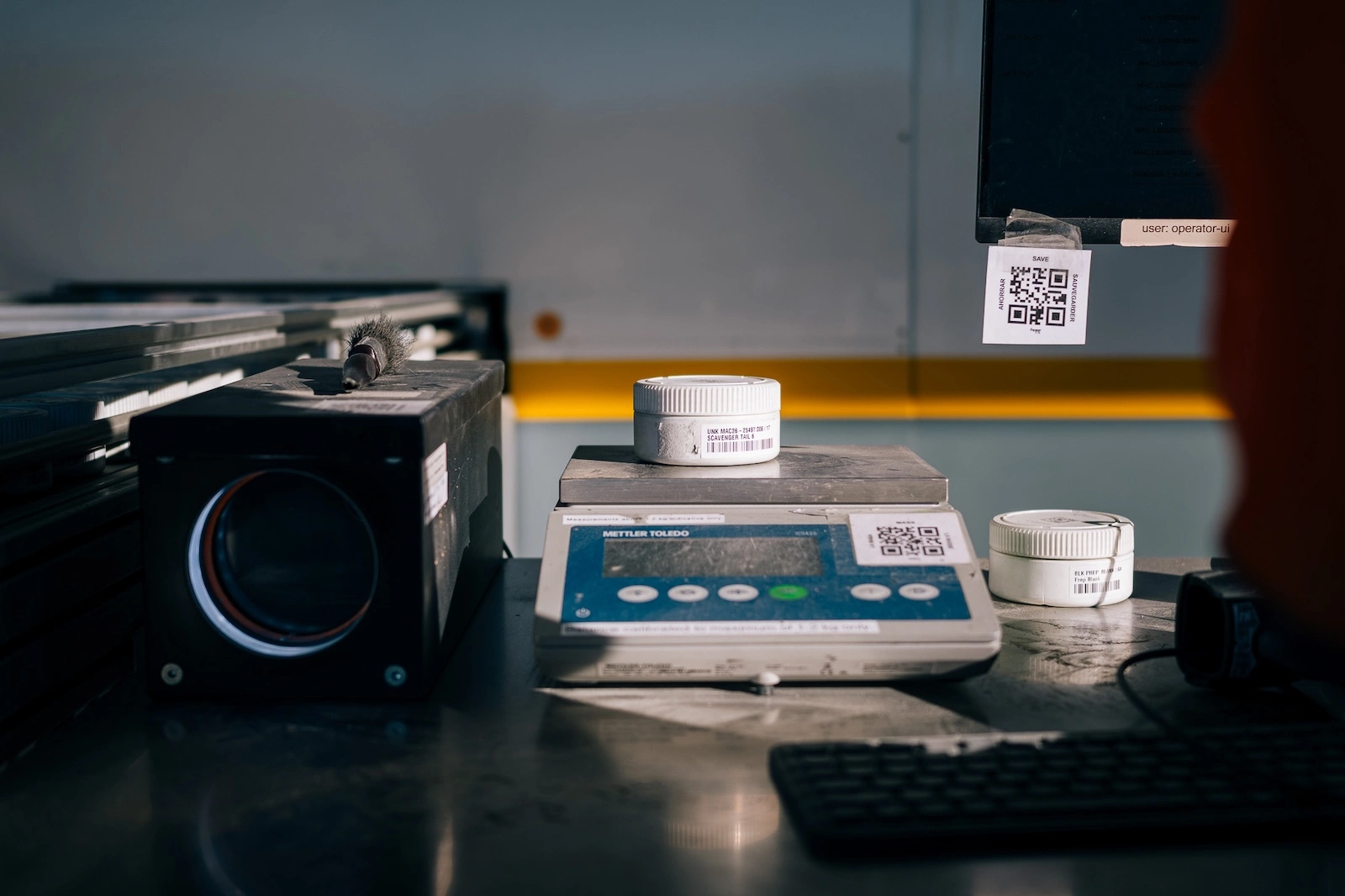 PhotonAssay™ sample jars being weighed on a laboratory balance during sample registration